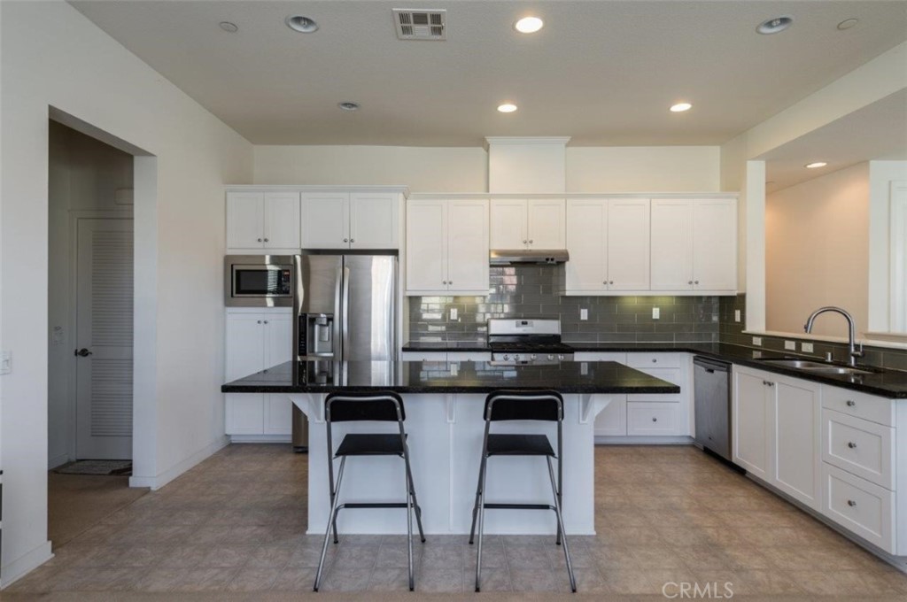 180 Borrego Irvine, CA 92618 - Photo 6 of 23 a kitchen with stainless steel appliances granite countertop a sink and stove