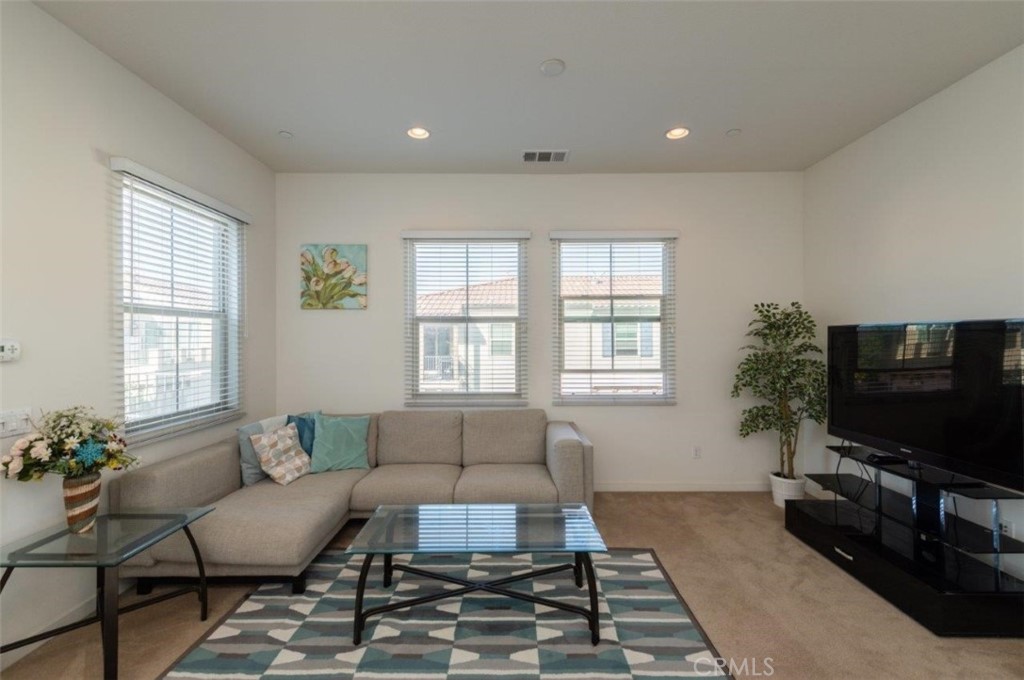 180 Borrego Irvine, CA 92618 - Photo 9 of 23 a living room with furniture and a flat screen tv