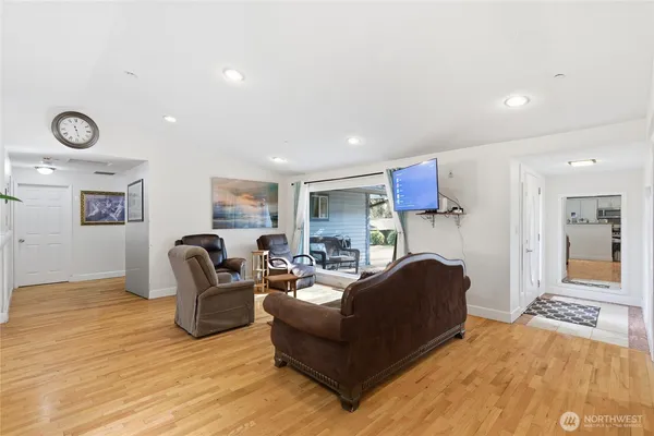 a living room with furniture and a wooden floor
