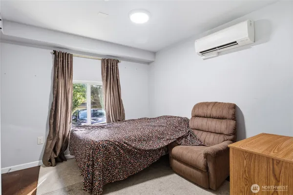 a bedroom with furniture and a window