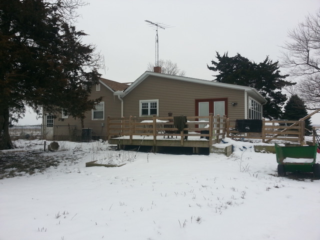 1453 Houghtby Road Shabbona, IL 60550 - Photo 3 of 22 a front view of a house with a yard covered with snow in front of house