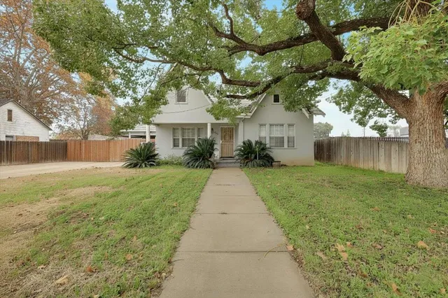 a front view of house with yard and green space