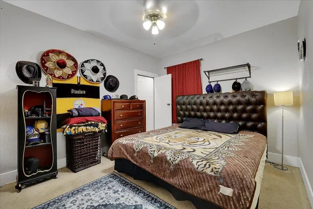 a bedroom with a bed and dresser