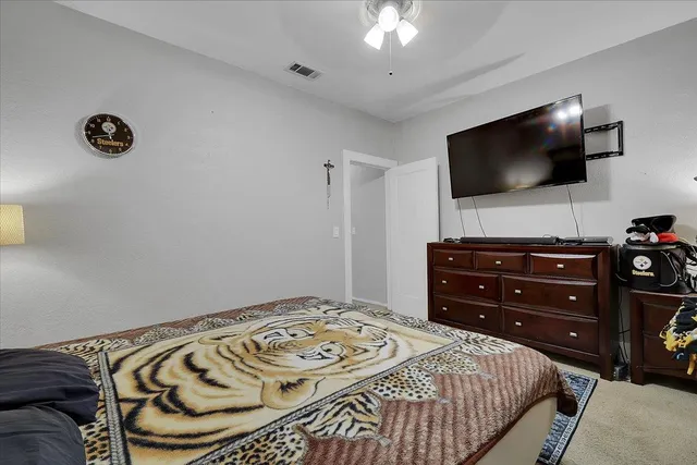 a bedroom with a bed and a flat screen tv