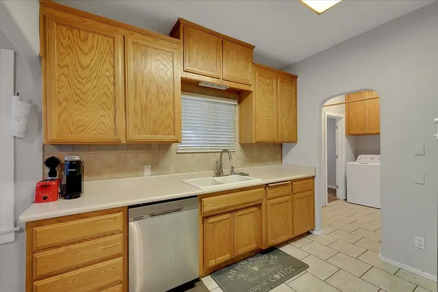 a kitchen with a sink cabinets and a window