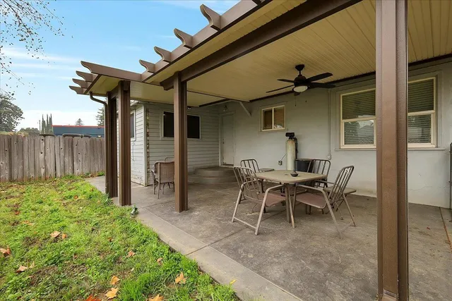 a backyard of a house with table and chairs