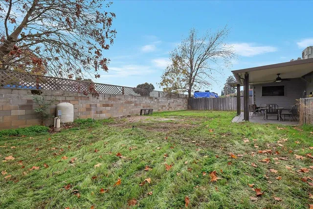 a backyard of a house with table and chairs