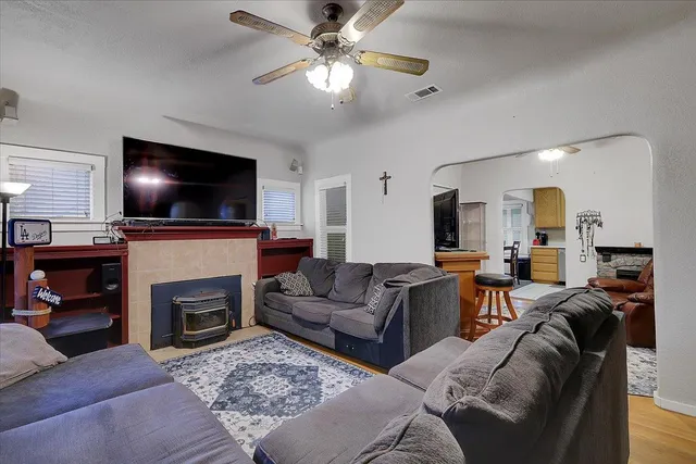 a living room with furniture a fireplace and a flat screen tv