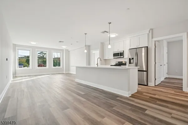a view of a kitchen with wooden floor and kitchen
