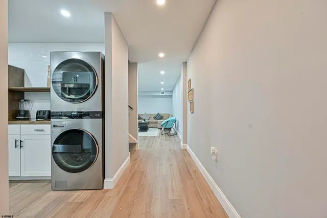 a view of a hallway with washer and dryer