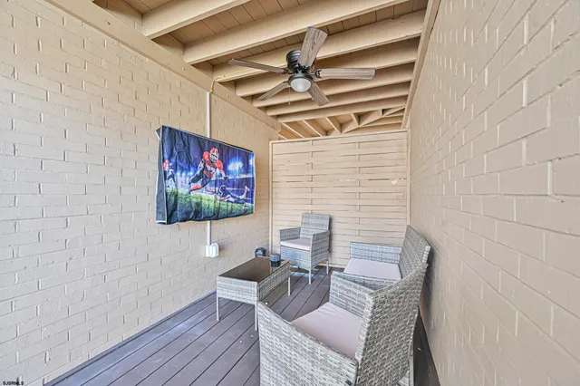 a view of a livingroom with lounge chair and a potted plant