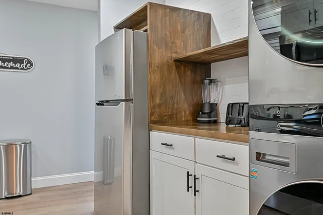 a kitchen with stainless steel appliances a refrigerator and cabinets