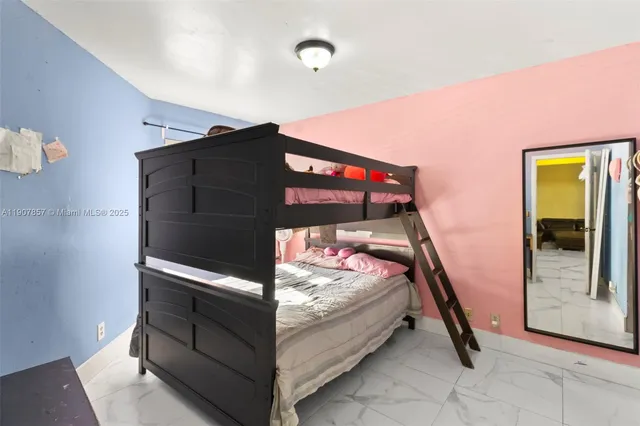 a bedroom with bed and a window