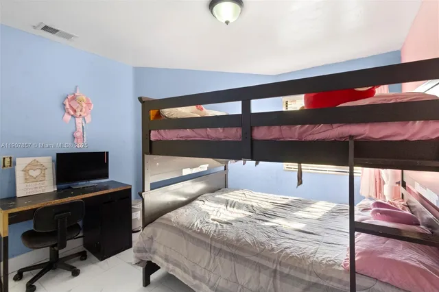 a bedroom with a bed and a desk