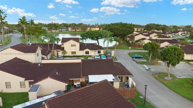 an aerial view of residential houses with outdoor space and street view