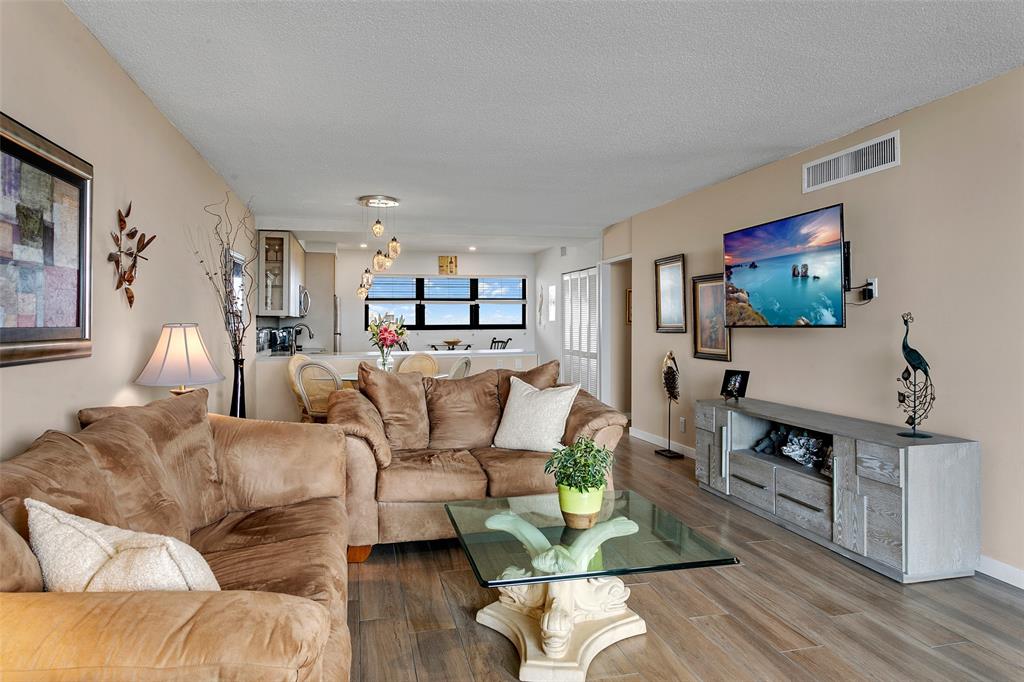 1401 North Riverside Drive, Unit PH1502 Pompano Beach, FL 33062 - Photo 11 of 32 a living room with furniture and a flat screen tv