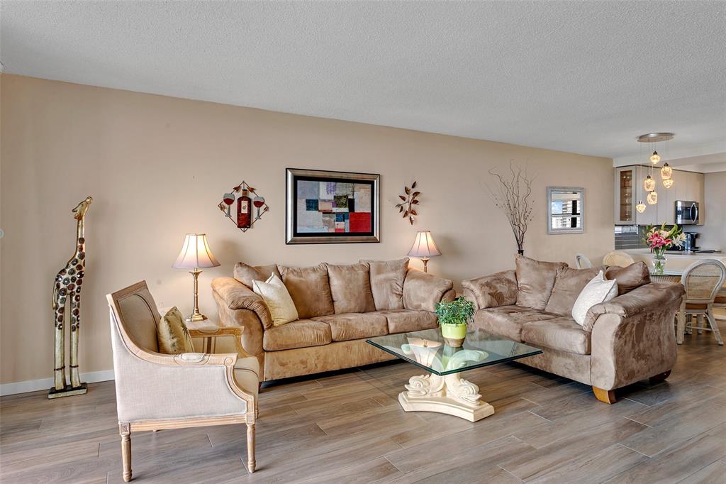 1401 North Riverside Drive, Unit PH1502 Pompano Beach, FL 33062 - Photo 13 of 32 a living room with furniture and a wooden floor