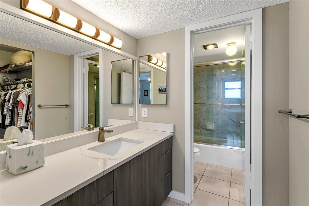 1401 North Riverside Drive, Unit PH1502 Pompano Beach, FL 33062 - Photo 17 of 32 a bathroom with a sink and a mirror