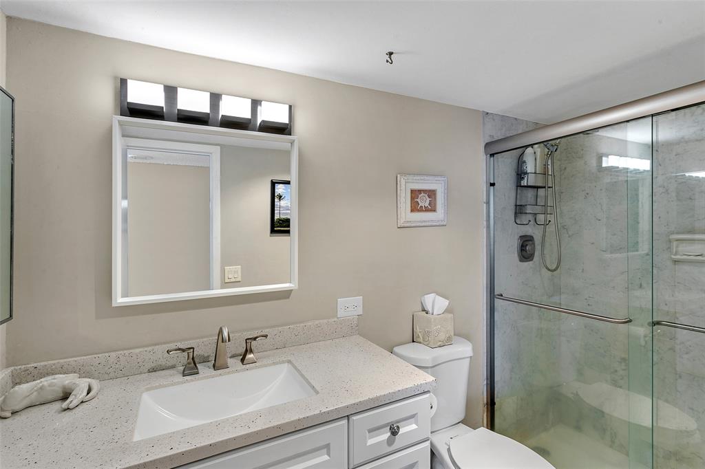 1401 North Riverside Drive, Unit PH1502 Pompano Beach, FL 33062 - Photo 20 of 32 a bathroom with a sink toilet and shower