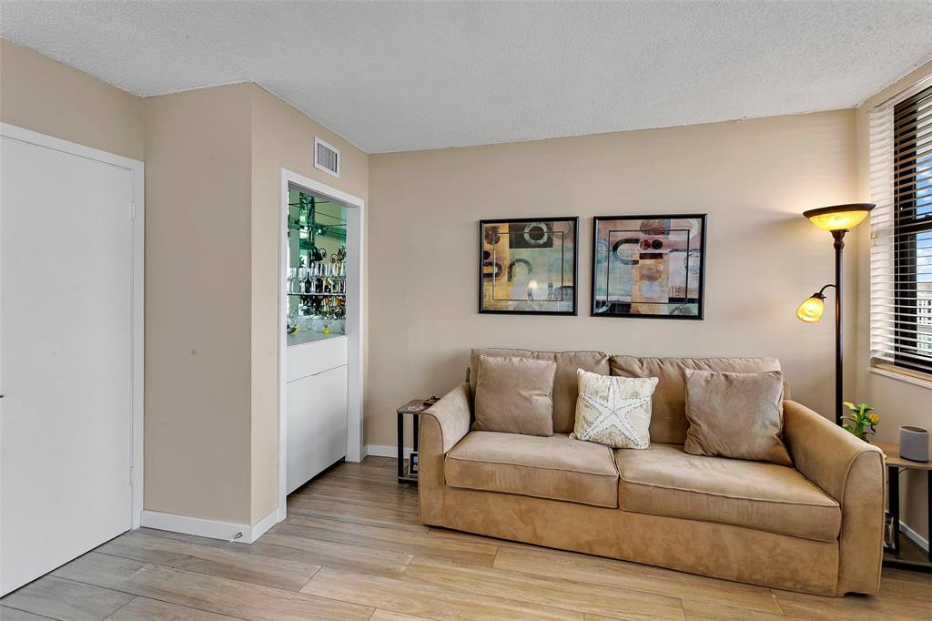 1401 North Riverside Drive, Unit PH1502 Pompano Beach, FL 33062 - Photo 21 of 32 a living room with furniture and painting on the wall