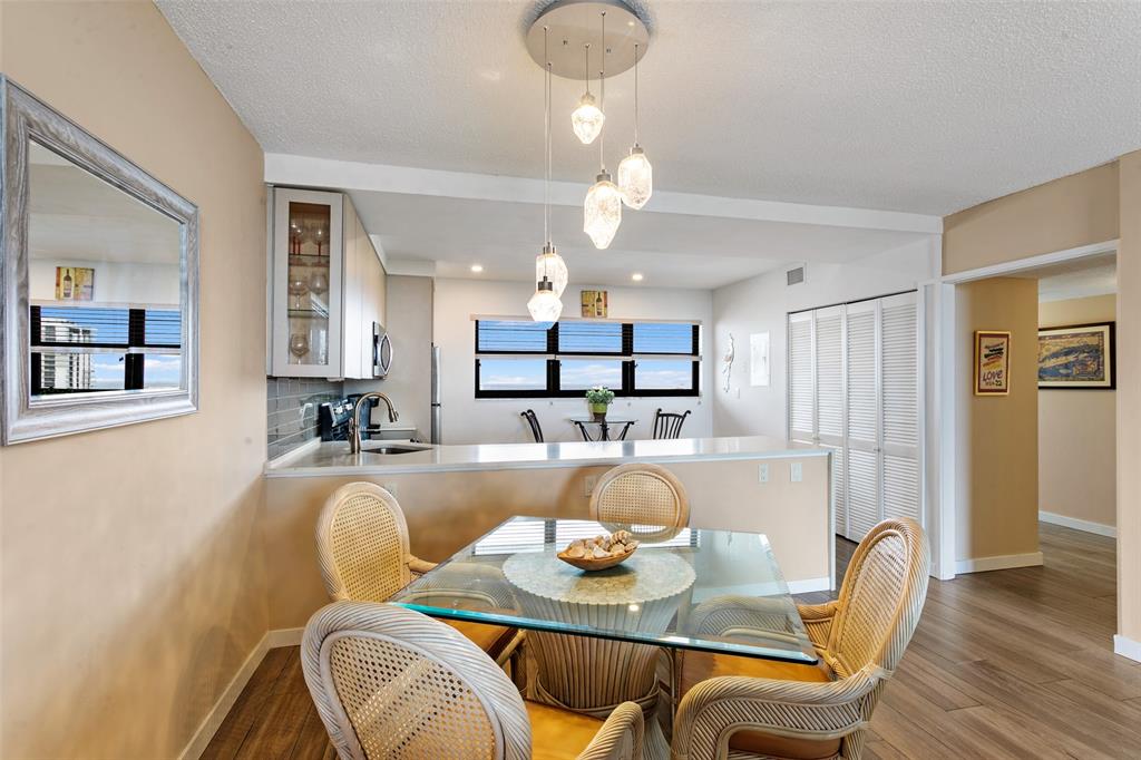 1401 North Riverside Drive, Unit PH1502 Pompano Beach, FL 33062 - Photo 8 of 32 a view of a dining room with furniture and wooden floor