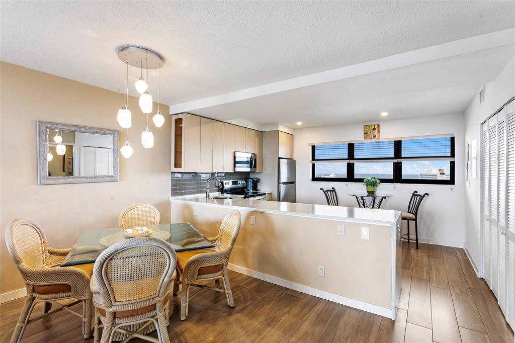 1401 North Riverside Drive, Unit PH1502 Pompano Beach, FL 33062 - Photo 9 of 32 a living room with furniture a dining table and kitchen view