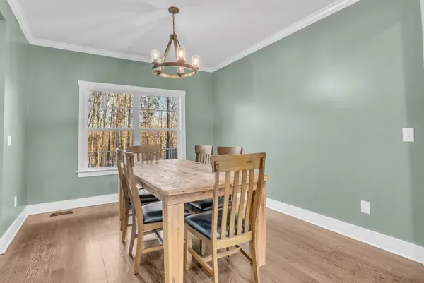 a view of a dining room with furniture window and wooden floor