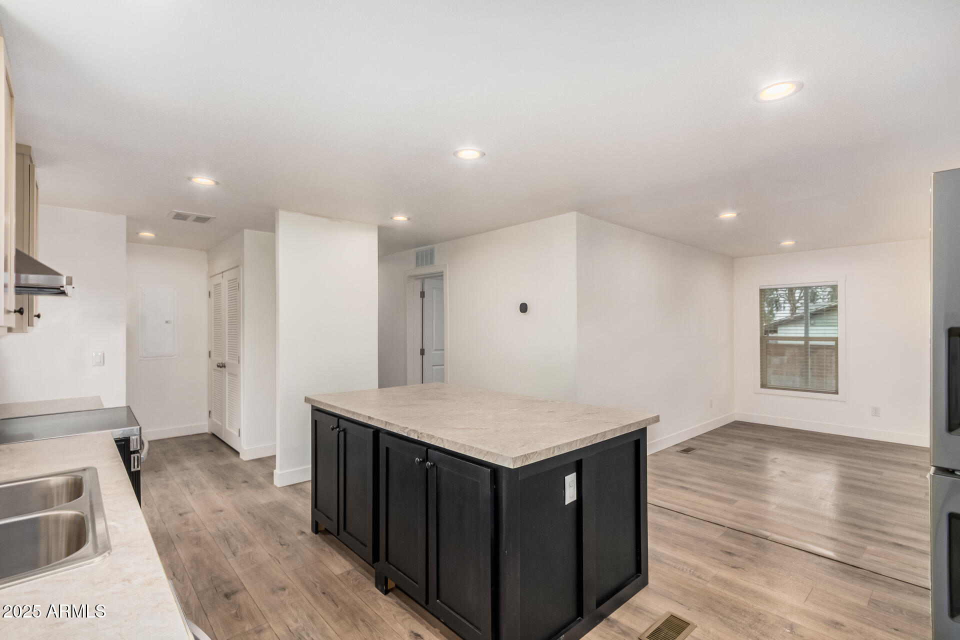 11441 East 4th Avenue Apache Junction, AZ 85120 - Photo 11 of 30 a kitchen with a wooden floor and large cabinets
