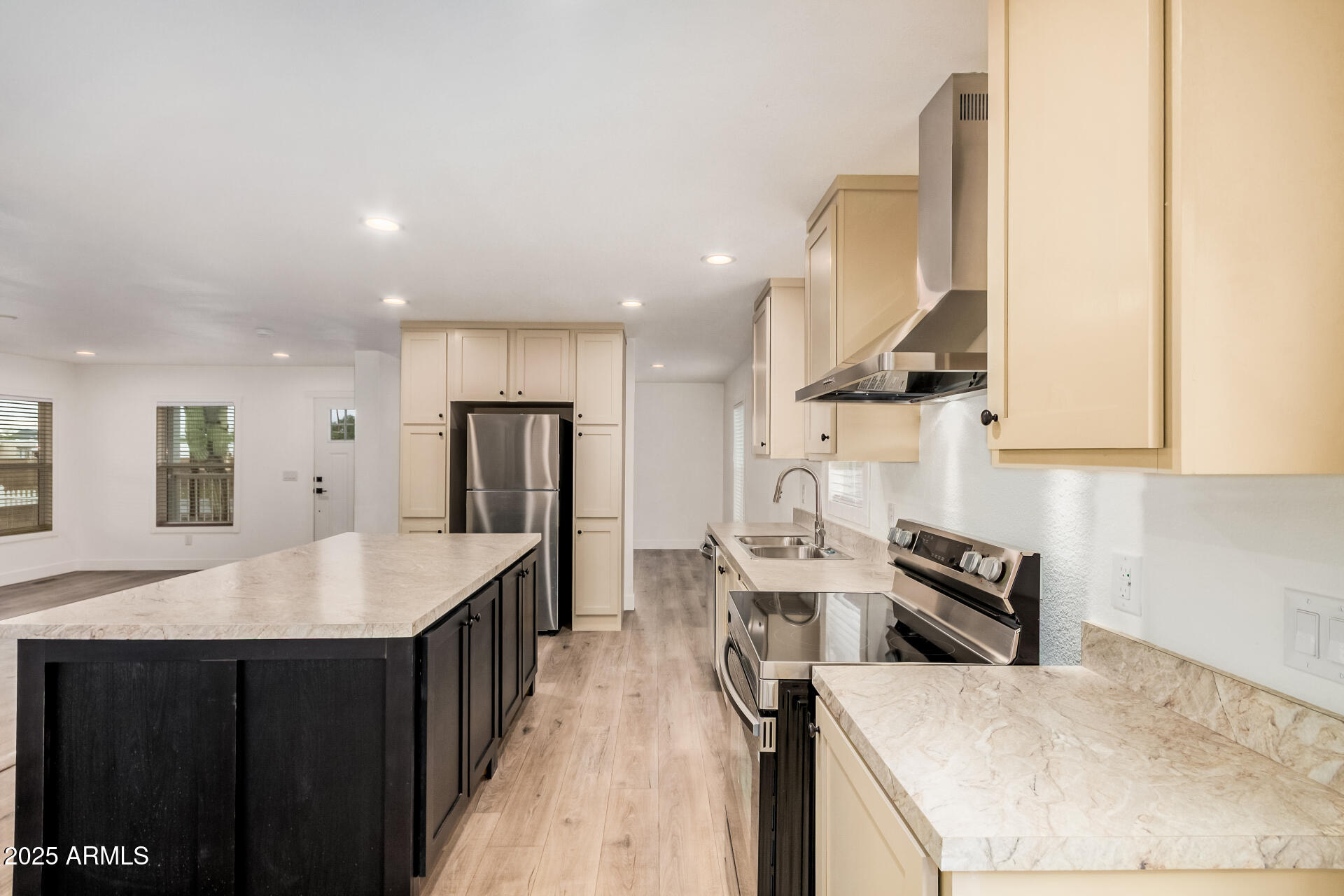 11441 East 4th Avenue Apache Junction, AZ 85120 - Photo 12 of 30 a kitchen with stainless steel appliances granite countertop a sink a stove and a refrigerator