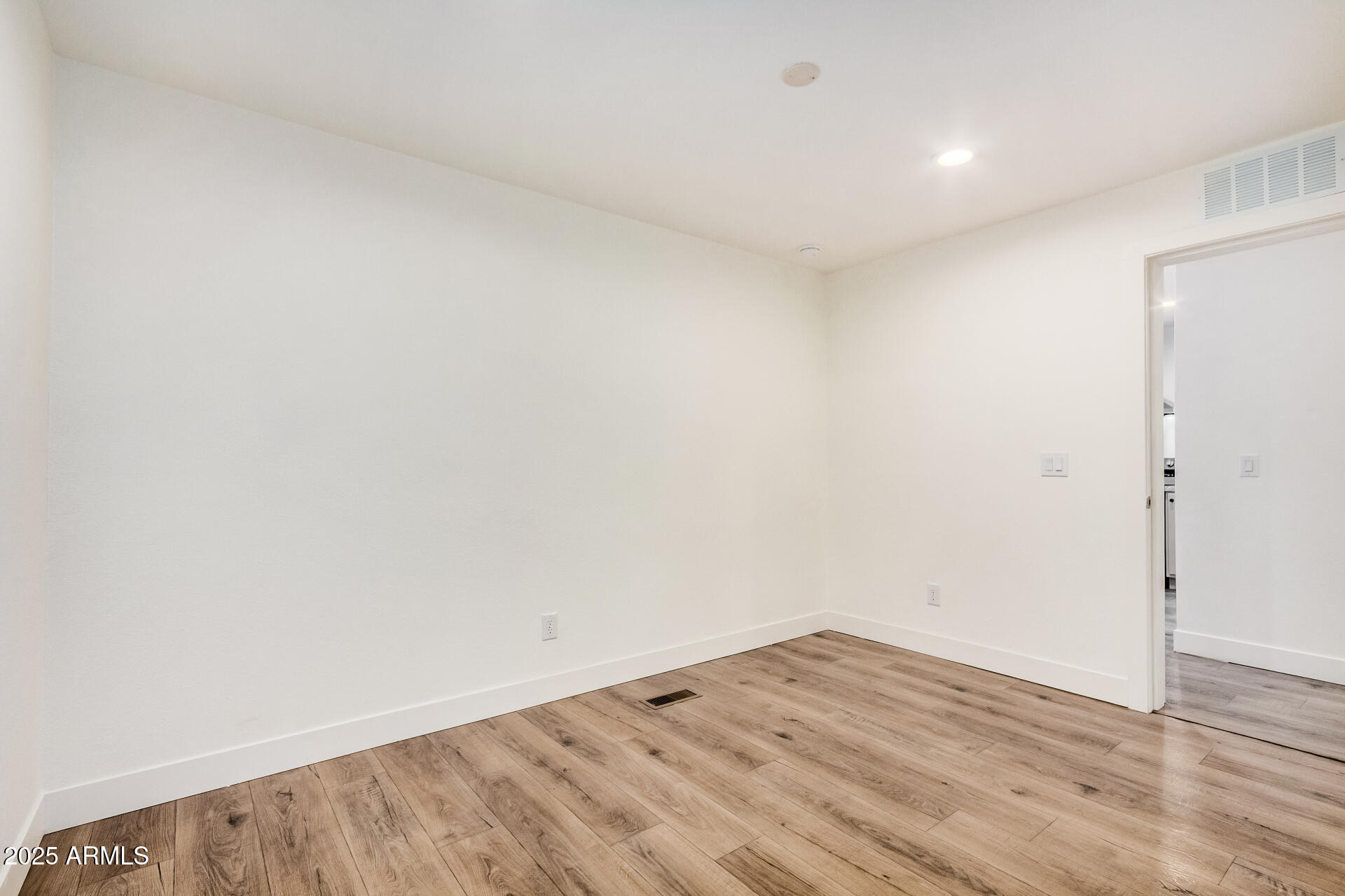 11441 East 4th Avenue Apache Junction, AZ 85120 - Photo 23 of 30 a view of empty room with wooden floor