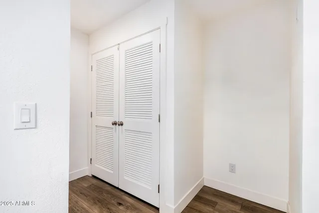 a view of a room with wooden floor