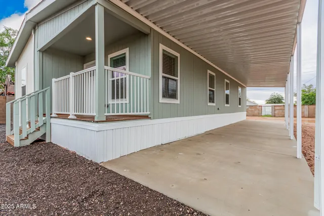 a front view of a house with wooden fence