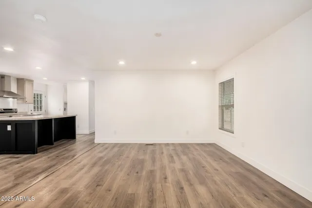 a view of kitchen with wooden floor and electronic appliances