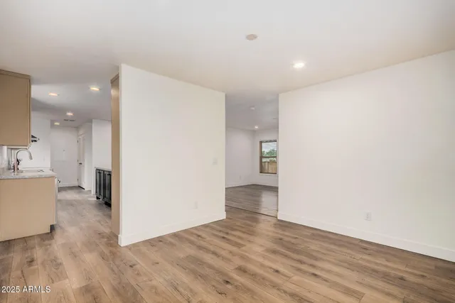 a view of a kitchen with wooden floor and a sink