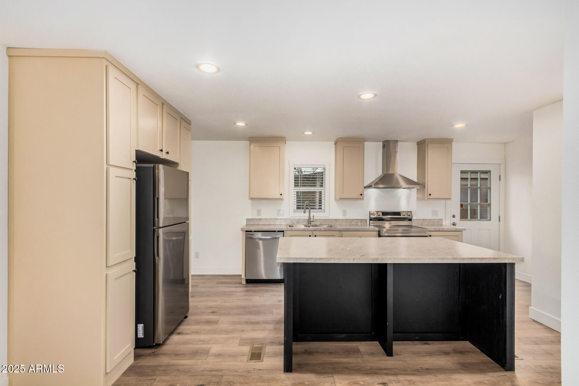 11441 East 4th Avenue Apache Junction, AZ 85120 - Photo 9 of 30 a kitchen with stainless steel appliances kitchen island granite countertop a refrigerator and a sink