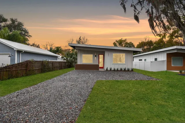 a front view of house with a garden