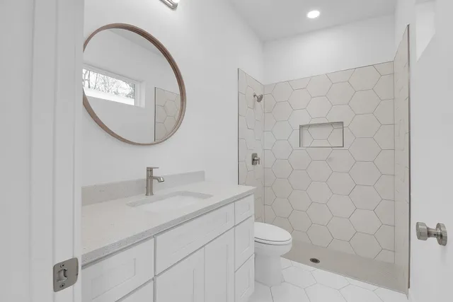 a bathroom with a white shower and a white bath tub