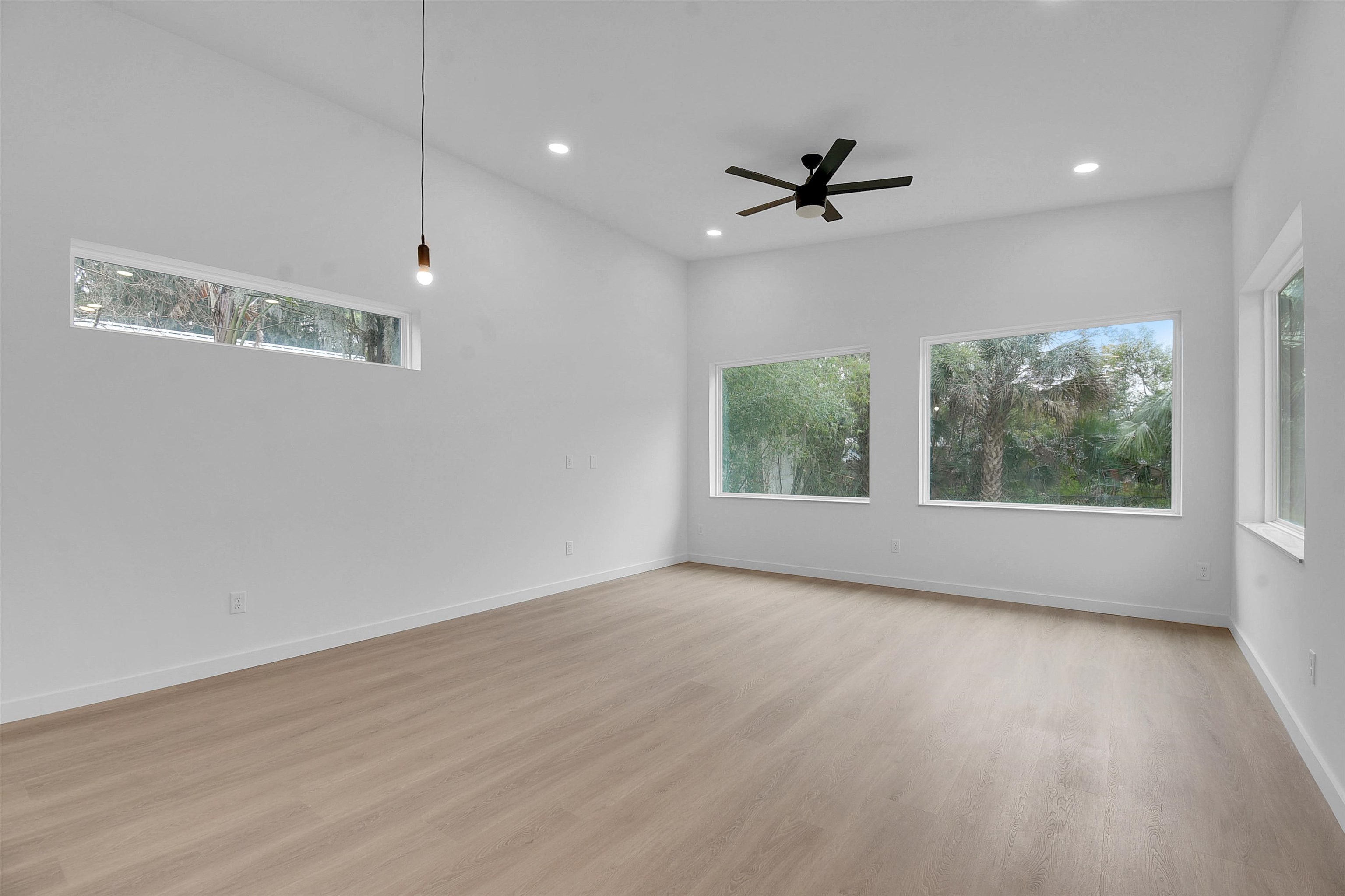 541 Columbus Street St. Augustine, FL 32084 - Photo 9 of 26 an empty room with wooden floor fan and windows