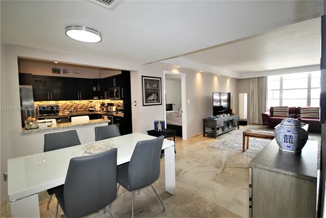 a living room with furniture and view of kitchen