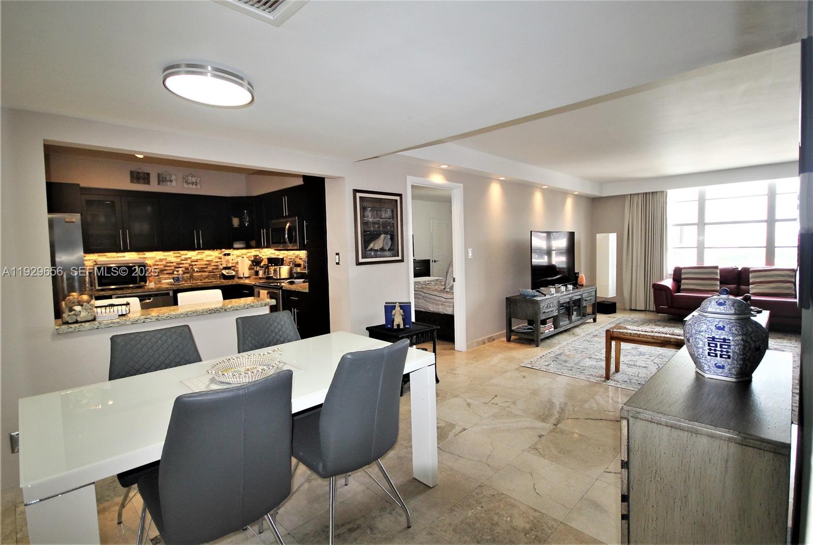 5161 Collins Avenue, Unit 1610 Miami Beach, FL 33140 - Photo 17 of 59 a living room with furniture and view of kitchen