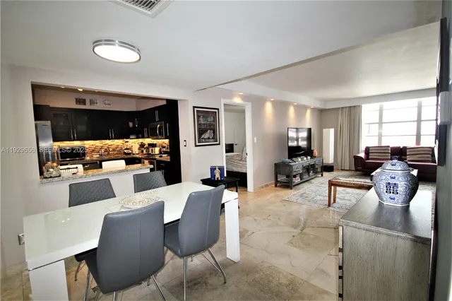 a dining room with furniture and window