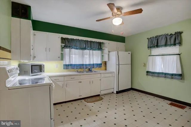 a kitchen with sink cabinets and refrigerator