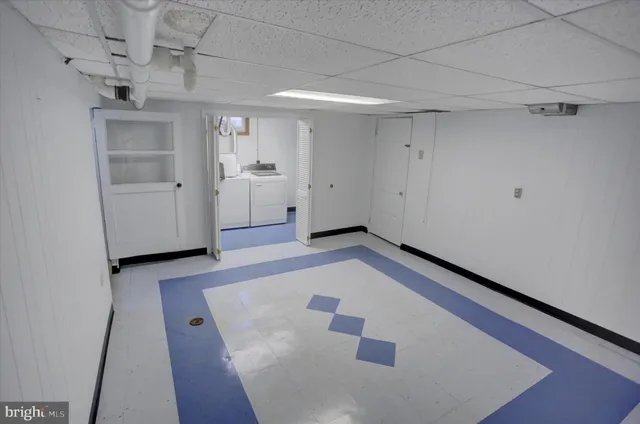 a view of a hallway with white walls and entryway