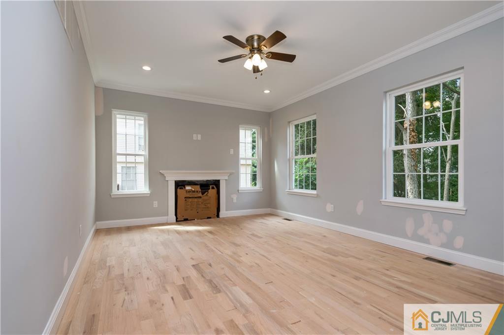 80 Ethel Road Edison, NJ 08817 - Photo 11 of 18 a view of an empty room with a window and a fireplace