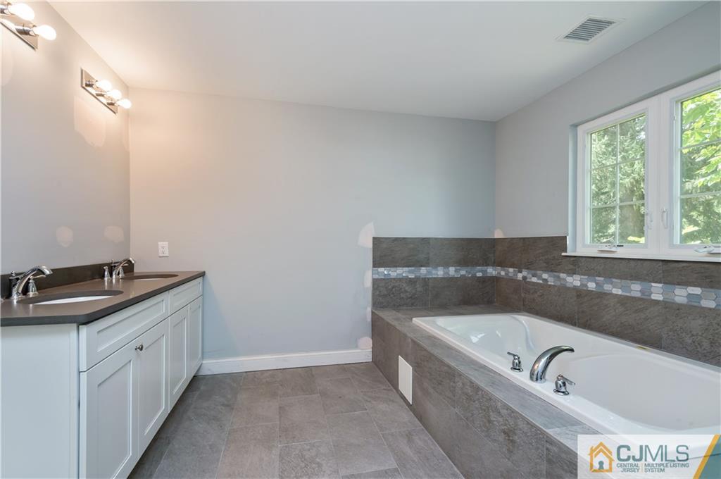 80 Ethel Road Edison, NJ 08817 - Photo 14 of 18 a bathroom with a tub sink and mirror