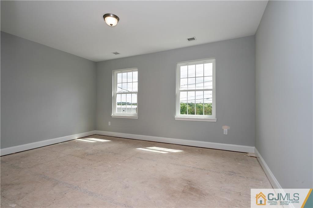 80 Ethel Road Edison, NJ 08817 - Photo 15 of 18 a view of an empty room with a window