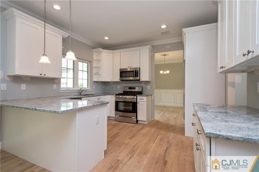 80 Ethel Road Edison, NJ 08817 - Photo 9 of 18 a kitchen with granite countertop a stove top oven and cabinets