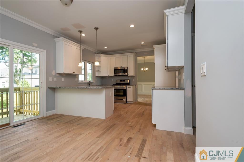 80 Ethel Road Edison, NJ 08817 - Photo 10 of 18 a kitchen with a refrigerator and a stove top oven