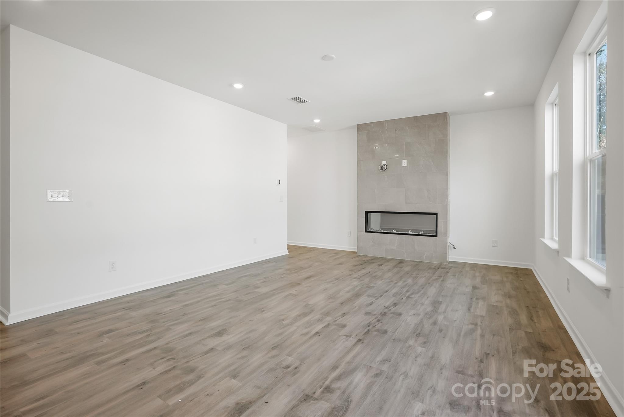 5007 Rill Court, Unit 35 Charlotte, NC 28262 - Photo 12 of 34 a view of an empty room with wooden floor and a window