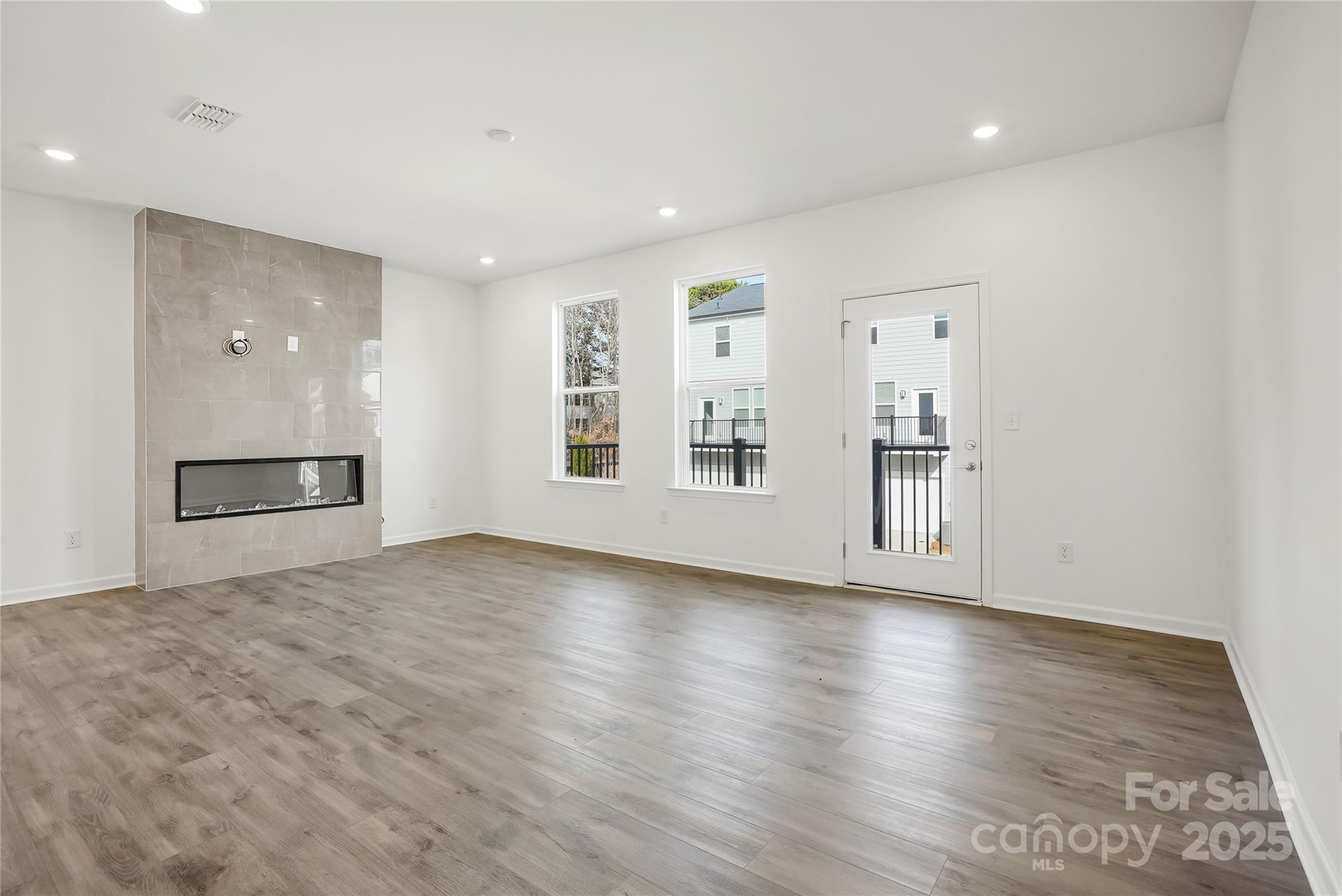 5007 Rill Court, Unit 35 Charlotte, NC 28262 - Photo 13 of 34 a view of an empty room with window and wooden floor